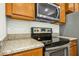 Stainless steel oven and range with light countertops and wood cabinets at 94 E Grove Point Dr, Clayton, NC 27527