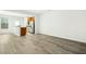 Spacious living room with plenty of natural light and durable wood-look floors at 94 E Grove Point Dr, Clayton, NC 27527