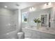 Well-lit bathroom with a shower-tub combo, dual sink vanity and modern fixtures at 35 Merle Dr, Wendell, NC 27591