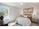 Cozy bedroom features carpet flooring, natural light and stylish decor at 35 Merle Dr, Wendell, NC 27591