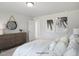 Inviting bedroom with a neutral color palette, dresser, and stylish decor at 35 Merle Dr, Wendell, NC 27591