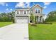 Charming two-story home with a gray exterior, well-manicured lawn, and a two-car garage at 35 Merle Dr, Wendell, NC 27591