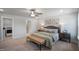 Bright and airy main bedroom with a king-size bed, ceiling fan, and convenient access to laundry and ensuite bathroom at 35 Merle Dr, Wendell, NC 27591