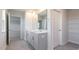Bathroom with double sinks, a large mirror, tile floors, and a closet with shelving at 100 Tobacco Woods Dr, Youngsville, NC 27596