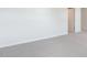 Spacious bedroom with neutral carpeting and white walls leads into another room at 100 Tobacco Woods Dr, Youngsville, NC 27596