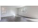 Bright bedroom with hardwood floors and natural light from two windows at 100 Tobacco Woods Dr, Youngsville, NC 27596