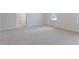 A bedroom that leads to another room with neutral-colored carpeting throughout the rooms at 100 Tobacco Woods Dr, Youngsville, NC 27596