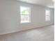Spacious bedroom with two windows offering natural light and neutral-toned carpeting at 100 Tobacco Woods Dr, Youngsville, NC 27596