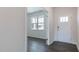 Inviting entryway featuring a white front door, hardwood floors, and a view into the adjacent living area at 100 Tobacco Woods Dr, Youngsville, NC 27596