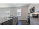 Open concept kitchen featuring an island, stainless steel appliances, gray cabinets, and access to the outdoor deck at 100 Tobacco Woods Dr, Youngsville, NC 27596