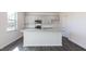 Modern kitchen featuring gray cabinets, granite countertops, stainless steel appliances, and a center island at 100 Tobacco Woods Dr, Youngsville, NC 27596
