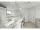 Bright bathroom with dual sinks, a large mirror, and a separate tub and shower at 1003 Frisco Ct, Durham, NC 27703