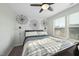 Sunny bedroom with unique wall decor, a ceiling fan, and large windows at 1003 Frisco Ct, Durham, NC 27703