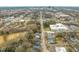 An aerial view showcasing the neighborhood, a nearby park with a swimming pool, and the city skyline at 1012 Holloway St, Durham, NC 27701