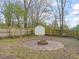 Backyard featuring a circular firepit area, perfect for outdoor gatherings and cozy evenings at 1012 Holloway St, Durham, NC 27701