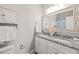 Bathroom with dual sinks, granite counters, framed mirror, and storage options at 1012 Holloway St, Durham, NC 27701