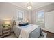 Cozy bedroom with natural lighting, decorative pillows, and side tables at 1012 Holloway St, Durham, NC 27701
