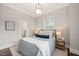 Comfortable bedroom featuring neutral tones, soft carpet, and natural light from the window at 1012 Holloway St, Durham, NC 27701