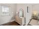 Stylish entryway featuring a console table with decor, mirror, and convenient access to a bedroom at 1012 Holloway St, Durham, NC 27701