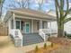 Charming single-story home featuring a welcoming front porch, gray siding, and a well-manicured yard at 1012 Holloway St, Durham, NC 27701