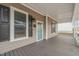 Spacious front porch with gray flooring and white trim, perfect for relaxing at 1012 Holloway St, Durham, NC 27701