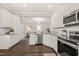Bright kitchen featuring white cabinets, granite counters, stainless appliances and seamless flow into an open living area at 1012 Holloway St, Durham, NC 27701
