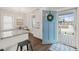 Bright kitchen featuring white cabinets, granite countertops, and a view to the front porch at 1012 Holloway St, Durham, NC 27701