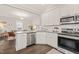Efficient kitchen with stainless steel appliances and sleek white cabinets at 1012 Holloway St, Durham, NC 27701