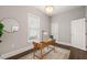 Well-lit home office with hardwood floors, neutral paint, and a wooden desk, perfect for work or study at 1012 Holloway St, Durham, NC 27701