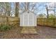 Backyard shed providing outdoor storage on a cloudy day with a wood surrounding fence at 1012 Holloway St, Durham, NC 27701