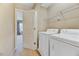 Practical laundry area featuring washer, dryer, and shelving for organization at 1019 Grand Ridge Dr, Rolesville, NC 27571