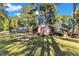 Expansive backyard with a fire pit, shed, and plenty of room for outdoor activities at 104 Piquot Drive, Louisburg, NC 27549