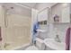 Bright bathroom with a shower-tub combo and ample storage in the vanity at 104 Piquot Drive, Louisburg, NC 27549
