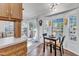 Cozy dining area featuring a black table with seating for two and bright light from a sliding glass door at 104 Piquot Drive, Louisburg, NC 27549
