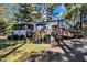 Charming single story home featuring a wooden deck, walkway and beautiful, mature landscaping at 104 Piquot Drive, Louisburg, NC 27549