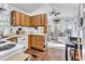 Open kitchen flowing into the living area, featuring wood cabinets and white appliances at 104 Piquot Drive, Louisburg, NC 27549