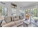 Cozy living room with a comfortable sofa, natural light from windows, and deck access at 104 Piquot Drive, Louisburg, NC 27549