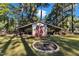 Outbuilding with a covered porch and space for storage, surrounded by trees at 104 Piquot Drive, Louisburg, NC 27549