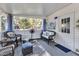 Inviting screened-in porch with cozy seating, fan, and outdoor view, perfect for relaxation at 104 Piquot Drive, Louisburg, NC 27549