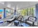 Sunroom with natural lighting, wicker furniture, and wooded outdoor view at 104 Piquot Drive, Louisburg, NC 27549
