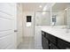 Modern bathroom showcasing a glass-enclosed shower, dark vanity, and decorative tile flooring at 106 Cottage Way # 33, Pittsboro, NC 27312