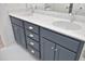 Bathroom vanity featuring dual sinks, modern chrome fixtures, and gray shaker style cabinets at 106 Cottage Way # 33, Pittsboro, NC 27312