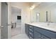 Bathroom featuring gray vanity with double sinks and white countertops and floors at 106 Cottage Way # 33, Pittsboro, NC 27312