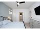 Comfortable bedroom with a ceiling fan, neutral tones, and easy access to other areas of the home at 106 Cottage Way # 33, Pittsboro, NC 27312