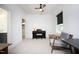 Large bedroom with sloping ceilings, carpet, black blind, ceiling fan, and adjacent bathroom at 106 Cottage Way # 33, Pittsboro, NC 27312