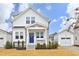 Charming two-story home features a bright blue front door, inviting porch, and well-maintained landscaping at 106 Cottage Way # 33, Pittsboro, NC 27312