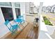 Cozy front porch with table and chairs, decorative flower pots, and wood-style flooring provides a peaceful retreat at 106 Cottage Way # 33, Pittsboro, NC 27312