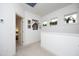 Bright hallway with carpet, picture frames on wall, and plants in window sills at 106 Cottage Way # 33, Pittsboro, NC 27312