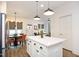Open-concept kitchen with white cabinets, modern lighting, and adjoining dining and living spaces at 106 Cottage Way # 33, Pittsboro, NC 27312