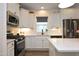 Updated kitchen featuring stainless steel appliances, white cabinets, and subway tile backsplash at 106 Cottage Way # 33, Pittsboro, NC 27312
